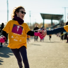 Girls on the Run participants high five one another at the finish line