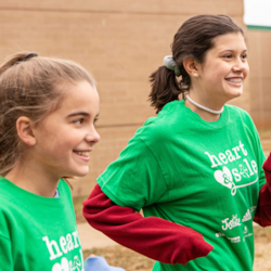 Two Heart and Sole participants smile while running in the program